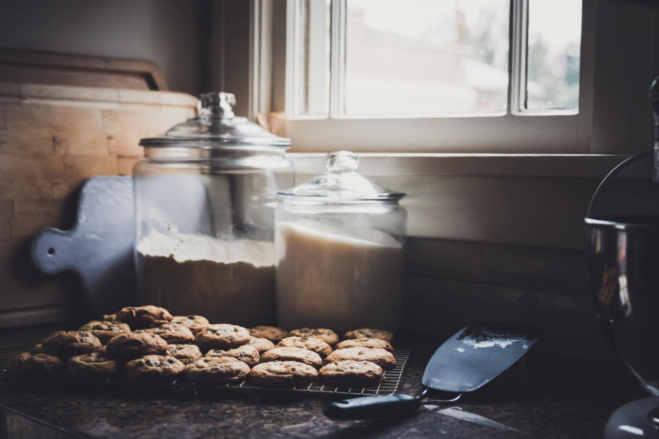 A tray of fresh cookies on a kitchen counter by the window