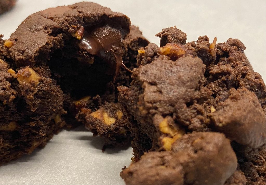 A warm double chocolate cookie broken open